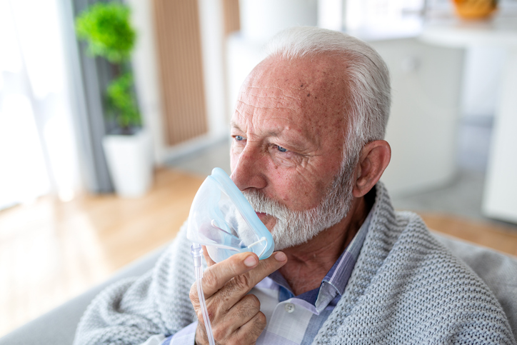 Patient holding a breathing mask